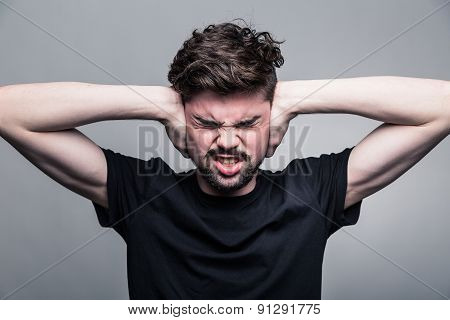 I need silence. Frustrated young man in shirt