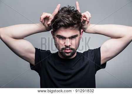Portrait of brutal bearded man with horns