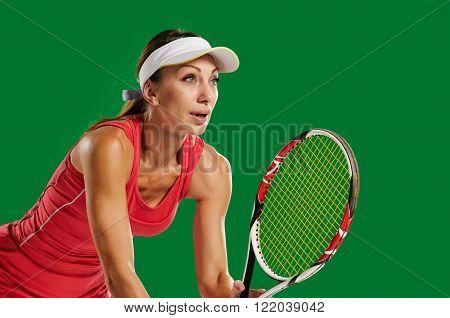 Woman playing tennis and waiting for the service. in a green screen studio.Young woman with copy space on green screen chroma key