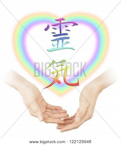 Sharing Reiki healing - Female cupped hands with a soft focus heart shaped rainbow and a rainbow colored Japanese Reiki Symbol floating above on a white background