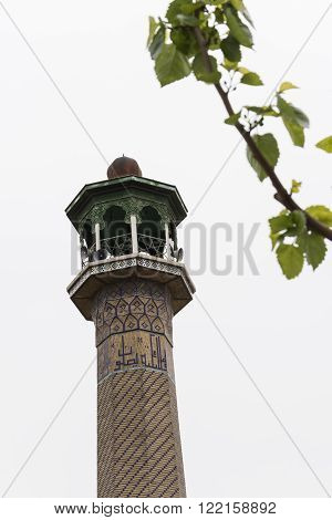 Iranian masque minaret isolated on white sky Tehran Urban Area.