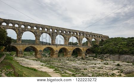 Pont du Gard in Provence France over the Gardon river is an 160 foot high roman aqueduct built to provide water to the city of Nimes from the river Eure near Uzes in the first century A.D.