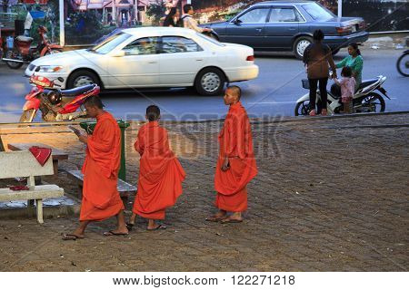 Cambodian Monks Walking On The Street In Kampot