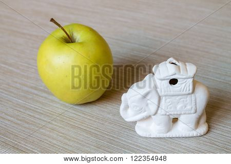 Elephant is a vegetarian. Apple and  figure of Elephant
** Note: Shallow depth of field