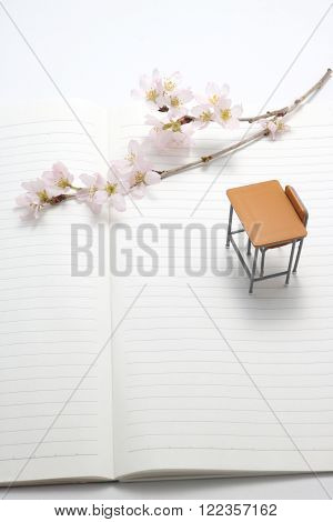 Study desk and cherry blossoms on the notebook.