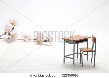 Study desk and cherry blossoms on the notebook.