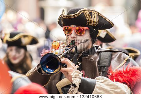 Baden Switzerland - February 14 2015: People in colorful fantasy costumes taking part in carnival Fastnachtsumzug parade in city of Baden Switzerland. Fasnachtsumzug typically involves a public celebration and parade combining some elements of a circus.