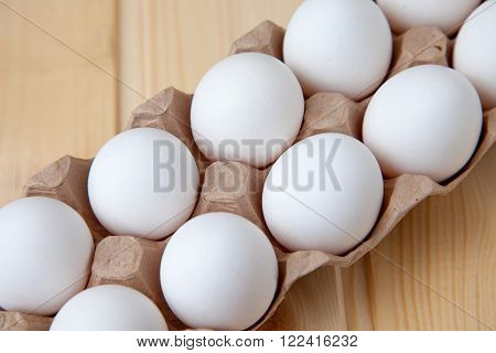 Fresh farm eggs on a wooden rustic background