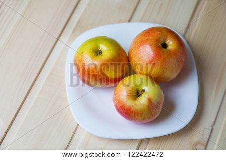 Apples In A Bowl On A Wooden Table