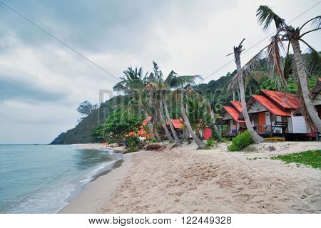 Cheap bungalows for backpackers on a tropical beach in evening time. Thailand