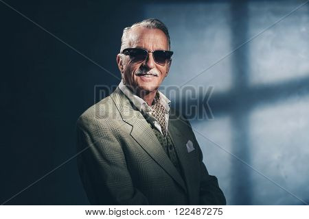 Smiling Vintage 1940 Senior Businessman Wearing Sunglasses. Studio Shot.