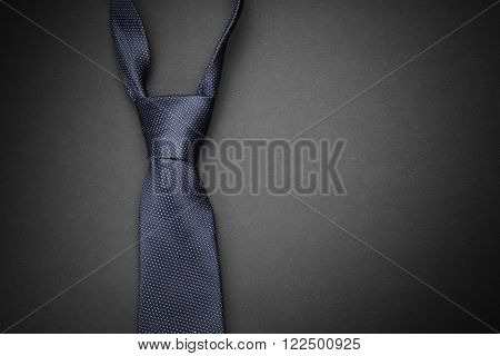 Elegant  blue tie on dark grey background