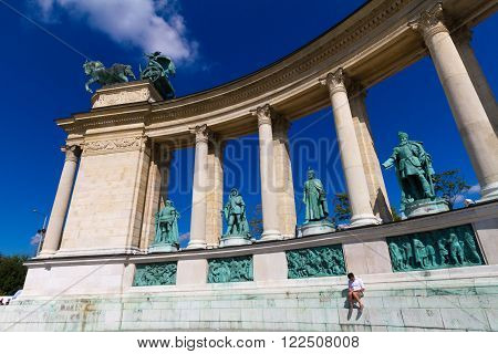 HUNGARY SEMPTEMBER 21 2014: Budapest Hungart. Heroe's Square with a seating tourist reading a book. H