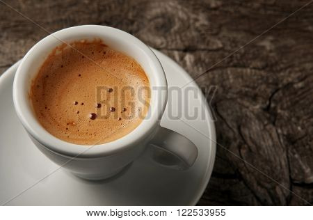 Closeup cup of coffee espresso with foam on top view with copy space. Coffee background