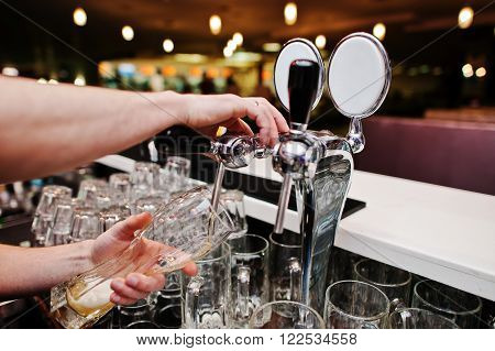 Close Up Of Barman Hand At Beer Tap