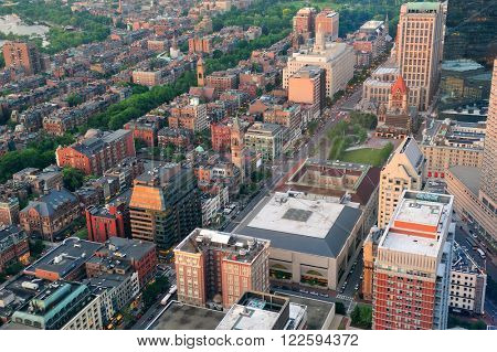 Boston city downtown aerial view with urban historical buildings at sunset.