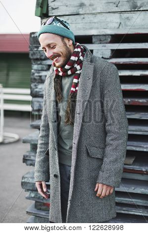 Cheerful young man in a coat and hat in an urban environment in the outdoor. Cheerful male hipster laughing.Lifestyle
** Note: Visible grain at 100%, best at smaller sizes