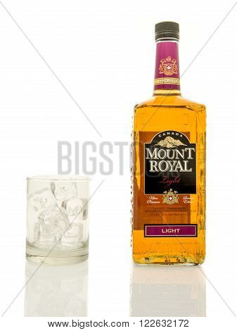 Winneconne WI - 19 March 2016: A bottle of Mount Royal whisky with a glass of ice.