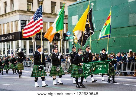 NEW YORK-MARCH 17- Marchers with flags dressed in kilts march in the St Patrick's Day Parade on on 5th Ave in New York City.