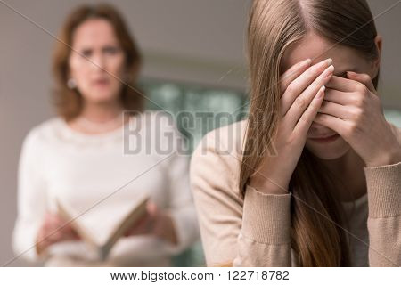 Embarrassed Teenage Girl And Mother With Her Diary