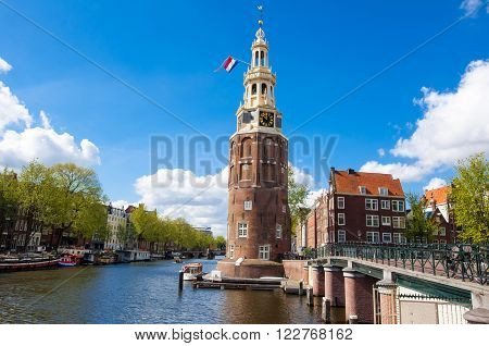 Amsterdam cityscape with the Montelbaanstoren tower on bank of the canal Oudeschans in Amsterdam the Netherlands.
