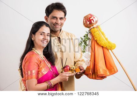 smart indian couple in traditional wear performing gudhi padwa puja, asian couple & puja thali, indian young couple with puja or pooja thali, hindu new year gudhi / gudi padwa, isolated on white