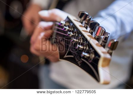 Detail of players guitar from rock concert