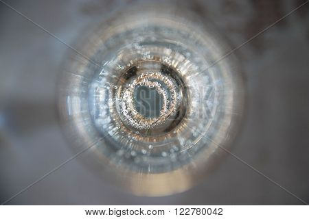 wedding rings inside a glass with champagne