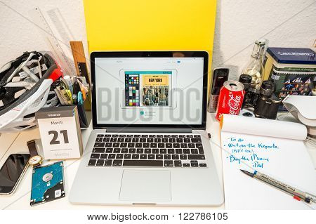 PARIS FRANCE - MARCH 21 2016: Apple Computers website on MacBook Pro Retina in a geek creative room environment showcasing the newly announced iPad Pro and Canva Retouch app