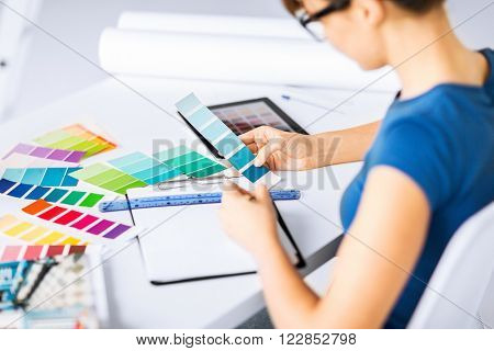 interior design and renovation concept - woman working with color samples for selection