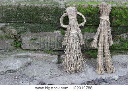 Figures of men made by children of dry grass