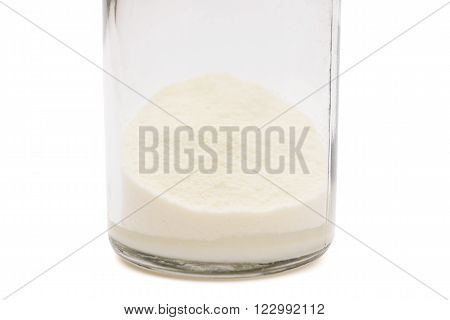 powdered milk in a bottle on white with clipping path