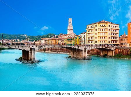 Verona, Italy. Scenery with Adige River and Ponte di Pietra at summer day with blue sky. Panorama. Ancient european Italian city
