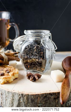 Jar With Tea, Homemade Cookies And  Spices For Tea On Dark   Background,