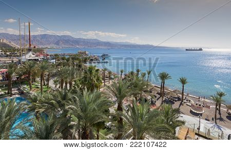 EILAT, ISRAEL - JANUARY 15, 2018: Aerial view on the Red Sea, central public beach and promenade in Eilat - famous vacation spot,  resort and recreational city in Israel and Middle East