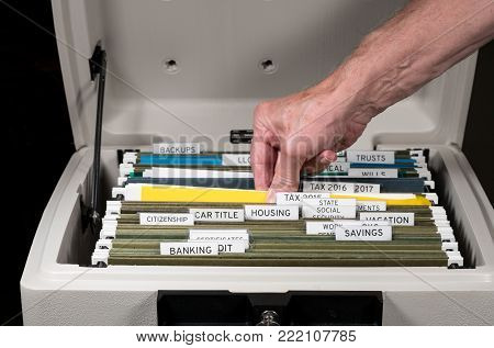 Close up of a well organized home filing system with tabs for each subject in fireproof safe