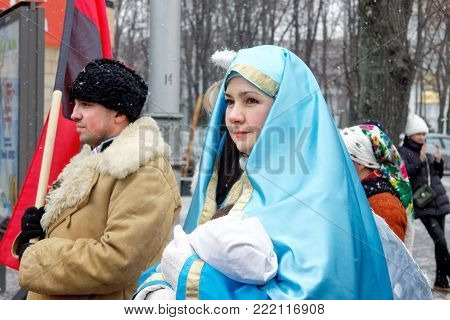 Kharkiv, Ukraine - January 13, 2018 - Participants traditional Christmas of Verteps Parade (nativity Scene), Christmas stars, carols singing. People wearing carnival clothes posing and smiling. Winter outdoor image.