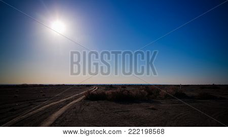 Sun above the bottom of Aral sea, Aralkum desert at Karakalpakstan, Uzbekistan