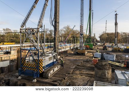 Driebergen, Netherlands - November 26, 2017: Construction site at the railway station in Driebergen, province Utrecht, with high cranes.