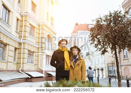 beautiful young couple in autumn outfit on city street