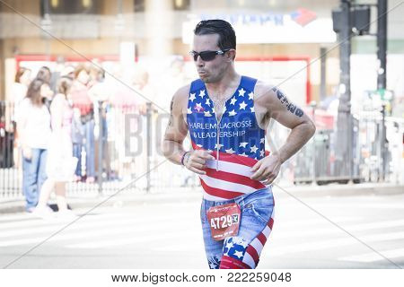 NEW YORK - JULY 16 2017: Athlete runs on West 72nd St during the 10k portion of the Panasonic New York City Triathlon Race, the only International Distance triathlon in NYC.
