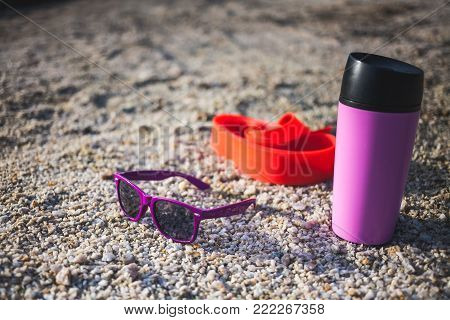 Gymnastic Gum, Thermo Mug And Glasses On The Sand.