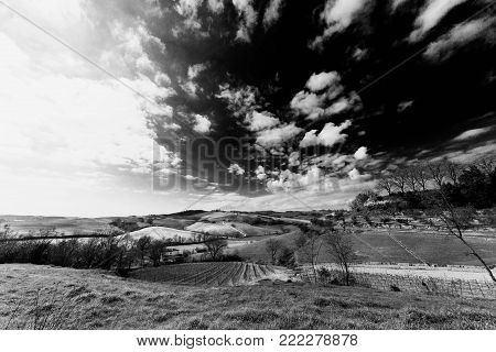 Panoramic view of the blue sky and rolling hills of the Tuscan countryside in autumn in Italy