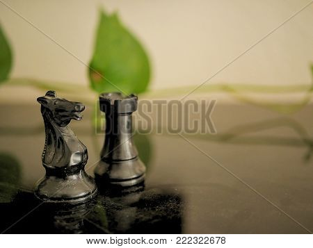 Chess Pieces Rook and Knight on Black Table