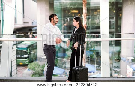 businessman and businesswoman talking at airport friend talking