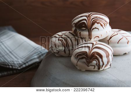 Delicate cakes on a vintage dish and wooden stool. background for a postcard, homemade food. concept for mother's day