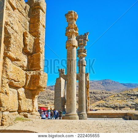 PERSEPOLIS, IRAN - OCTOBER 13, 2017: The ruins of All Nations Gate (Xerxes Gate) with preserved slender carved columns, Persepolis archaeological site, on October 13 in Persepolis.