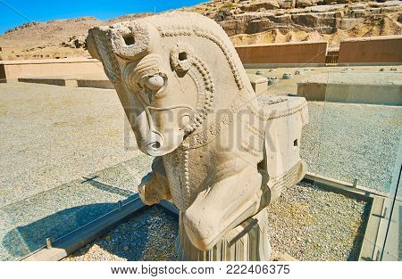 The small half-horse protome at the foot of rocky Rahmet Mount in ancient Persepolis, Iran.