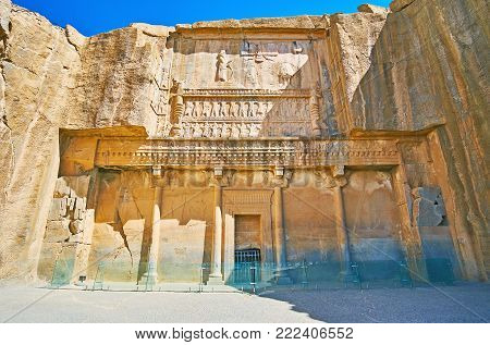 PERSEPOLIS, IRAN - OCTOBER 13, 2017: The facade of the ancient tomb of Artaxerxes III, located on the slope of Rahmet Mount, on October 13 in Persepolis.