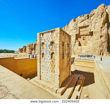NAQSH-E RUSTAM, IRAN - OCTOBER 13, 2017: Discover Ka'ba-ye Zartosht tower and ancient mausoleums in rock in Naqsh-e Rustam Necropolis, on October 13 in Naqsh-e Rustam.